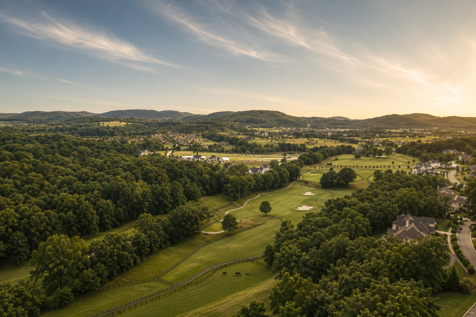 Representative editorial landscape of rolling hills, open fields and homes in evening light, not a specific property